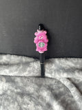 Pink bear on black pen