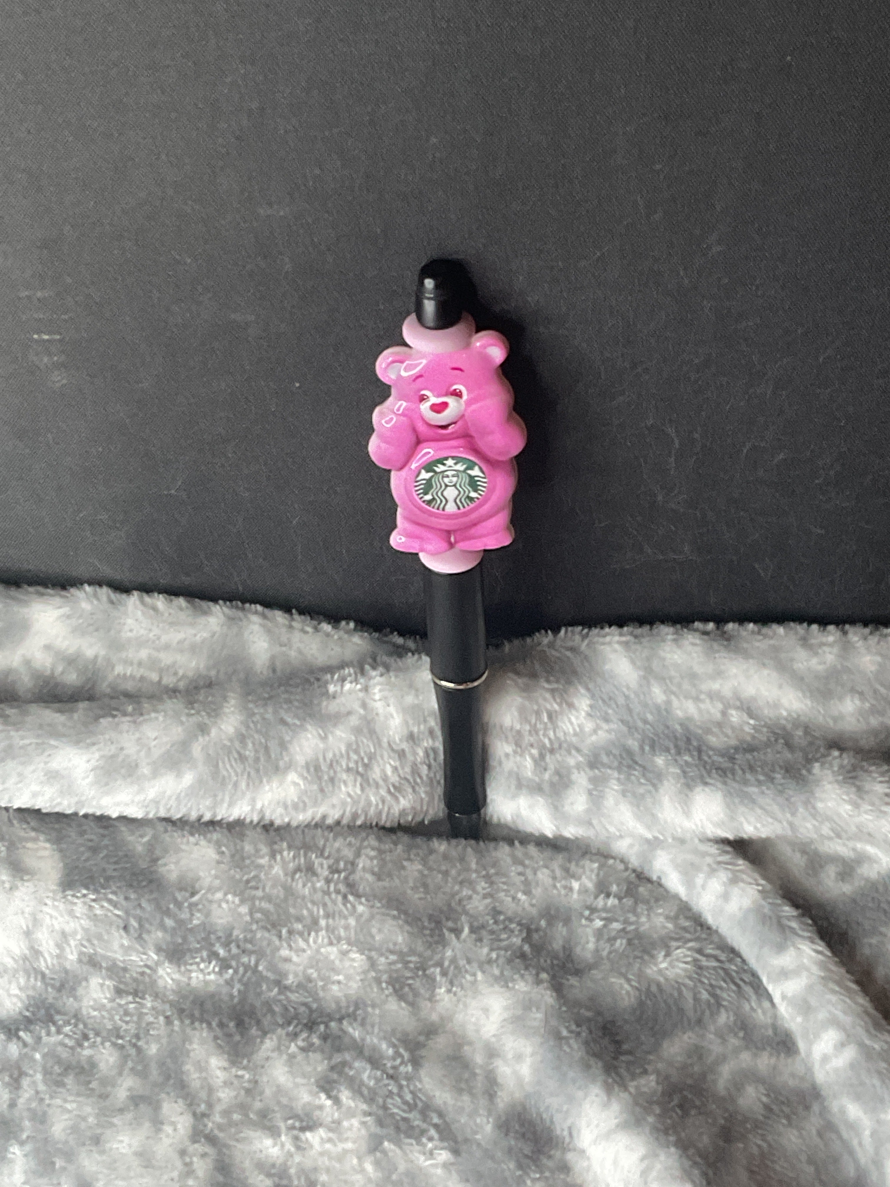 Pink bear on black pen