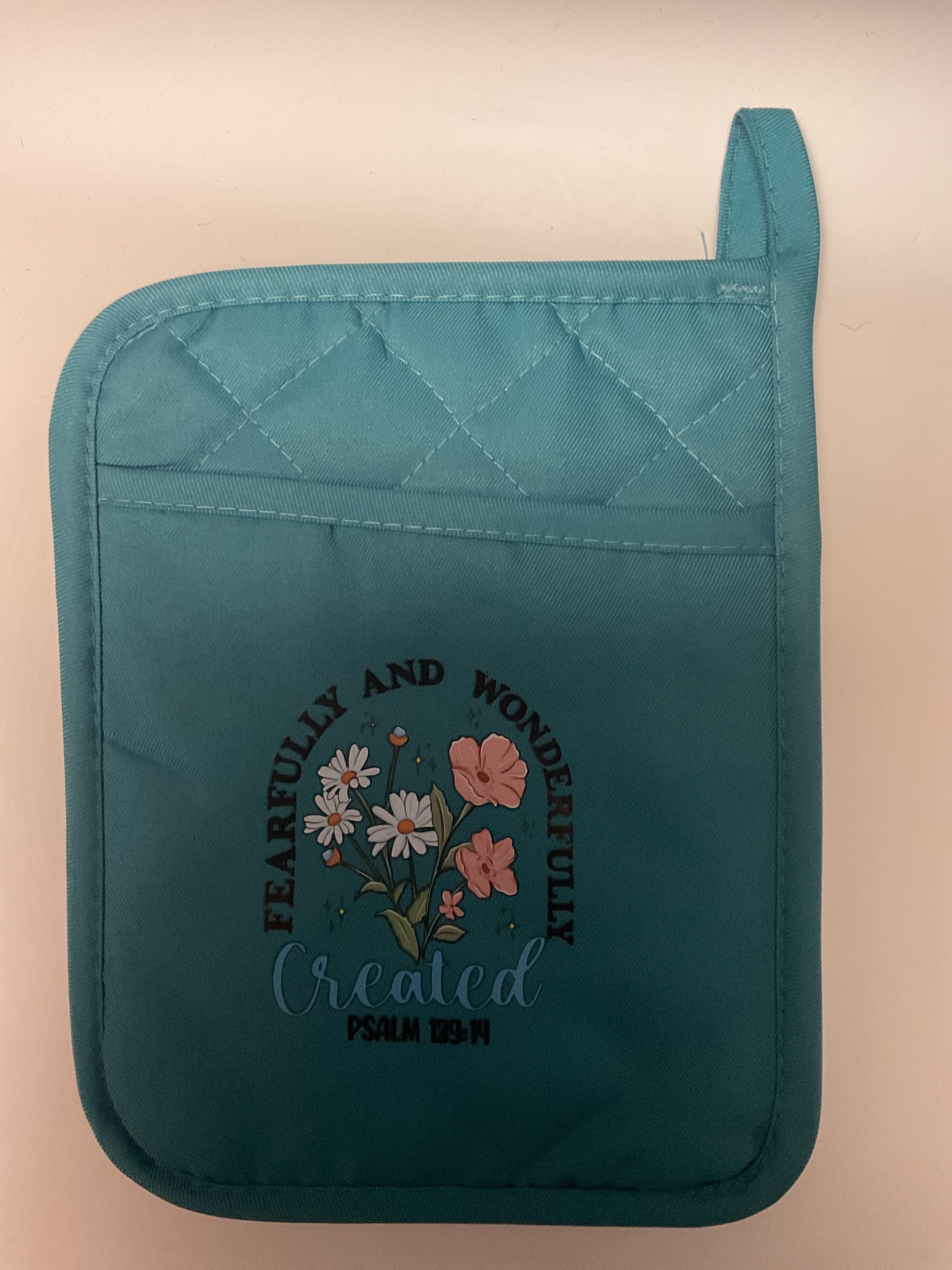 Fearfully and wonderfully created oven mitt