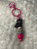 Black pug with a pink collar keychain ￼