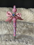 Pink and purple pen with a pink bow