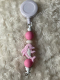 Pink dolphin, badge reel