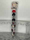 HK with red and black beads on a bow pen