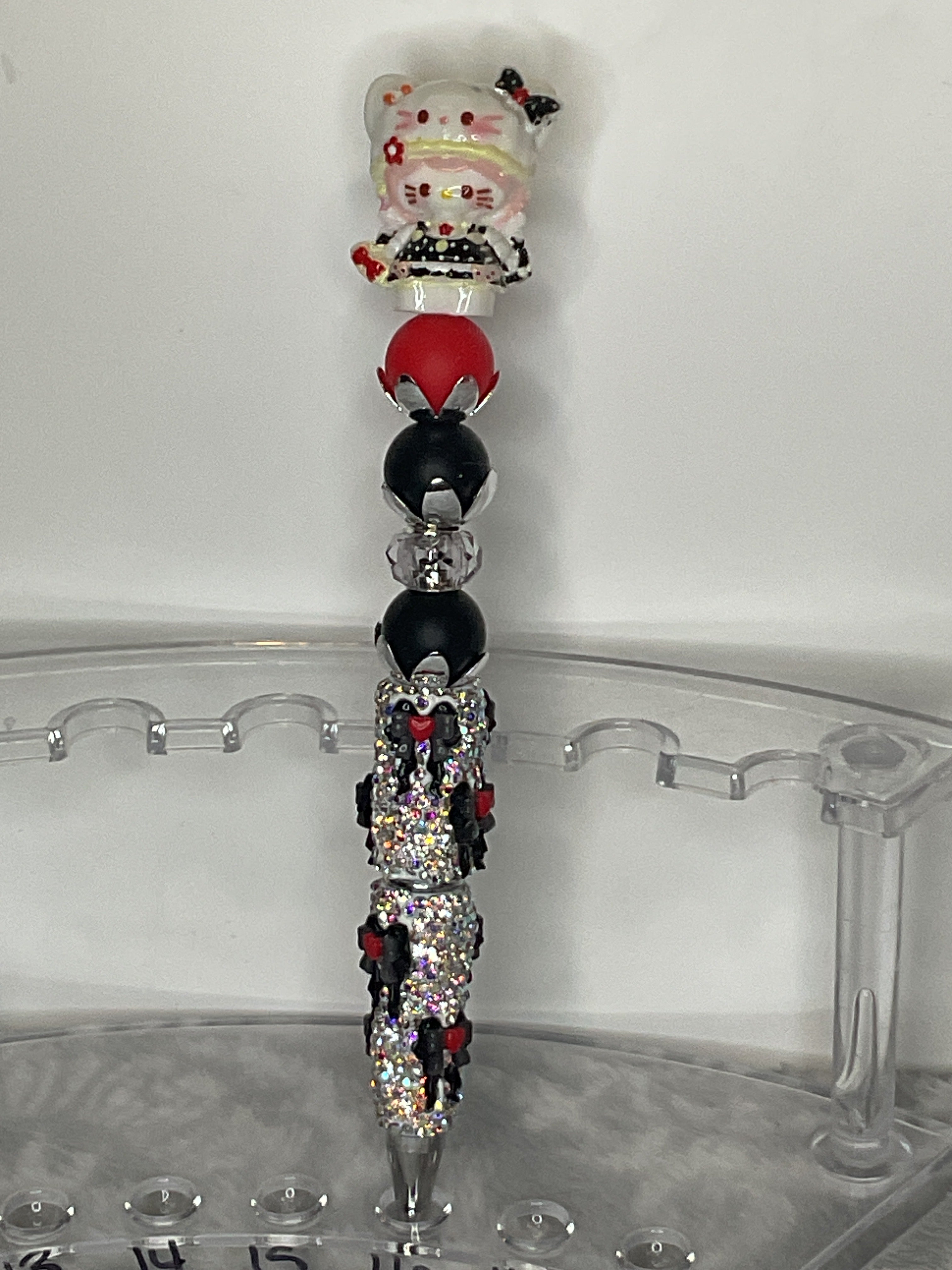 HK with red and black beads on a bow pen