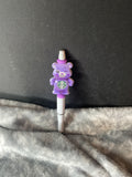 Purple bear on white pen