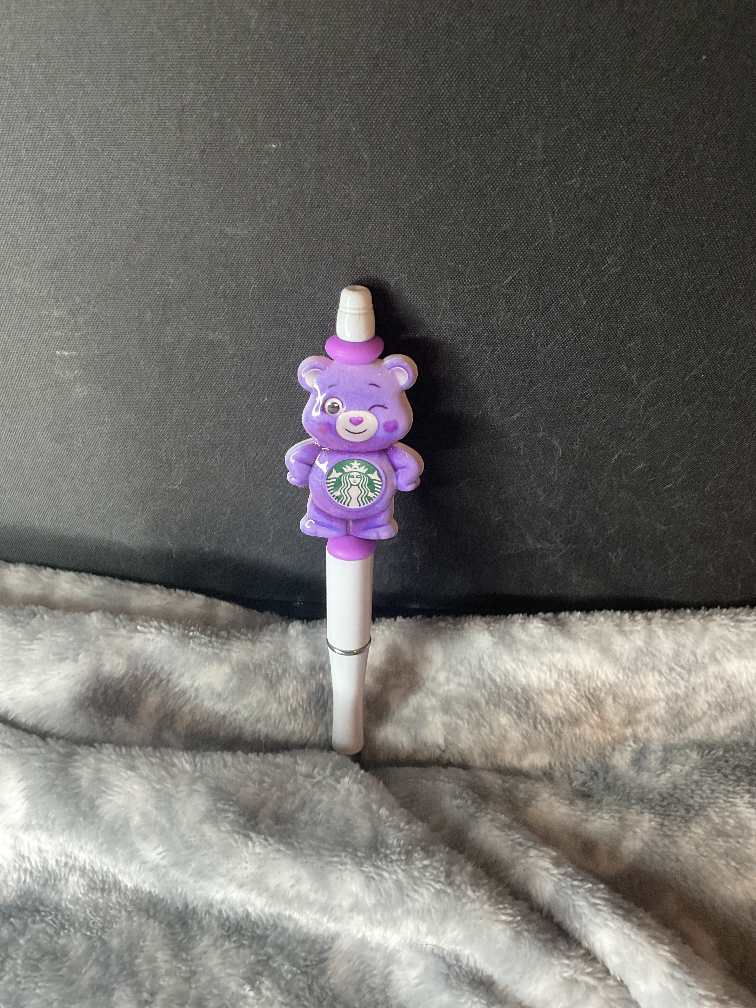 Purple bear on white pen
